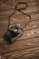 retro photo camera on wooden table with copy space