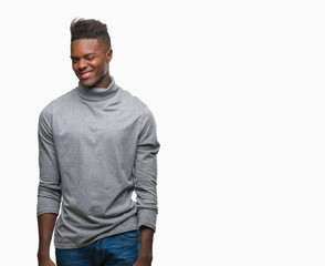 Fototapeta premium Young african american man over isolated background winking looking at the camera with sexy expression, cheerful and happy face.
