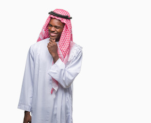 Young arabic african man wearing traditional keffiyeh over isolated background looking confident at the camera with smile with crossed arms and hand raised on chin. Thinking positive.