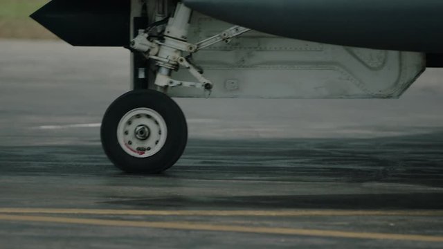 Fighter Jet close up view of wheel on the runway.