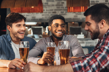 Best friends meeting and drinking beer in bar