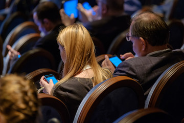 People attend business conference in congress hall