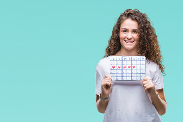 Young brunette girl holding menstruation calendar over isolated background with a happy face standing and smiling with a confident smile showing teeth