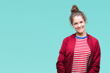 Beautiful brunette curly hair young girl wearing a jacket over isolated background with a happy and...