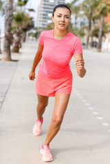 Sporty girl running outdoors