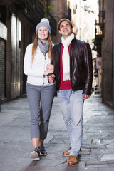 Fototapeta premium Positive male and female walking in autumn