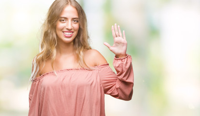 Beautiful young blonde woman over isolated background showing and pointing up with fingers number five while smiling confident and happy.