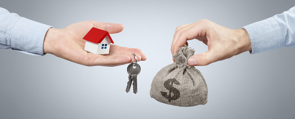 Hands changing a burlap sack full of dollars for keys from a small red-roofed house on gray background