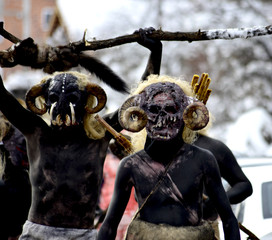  unrecognizable men wearing  mask on  at  Vevcani Carnival, in southwestern Macedonia
