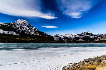 Ice still covers the lake at Barrier Lake Dam, Bow Valley Provincial Park, Alberta, Canada