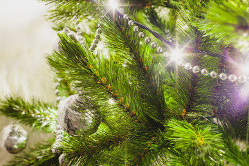 decorations on an artificial green christmas pine tree at home