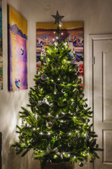 an artificial green christmas pine tree at home