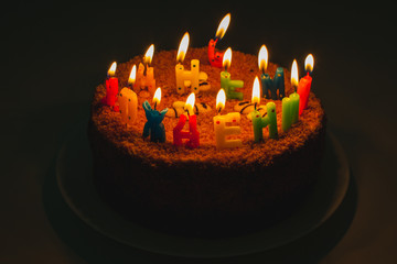 a birthday cake with letter shaped candles in russian 