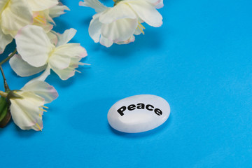White flowers with a stone that depicts tranquility and peace.