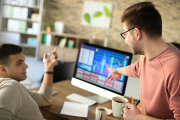 Fototapeta premium Young men working in office