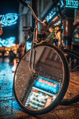 Picture of bicycle with mirror on the wheel on the night street