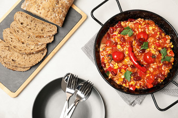 Flat lay composition with chili con carne on light background