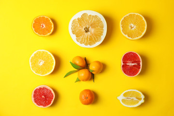 Different citrus fruits on color background, flat lay