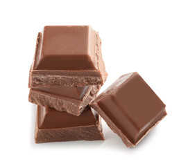 Pieces of tasty milk chocolate on white background