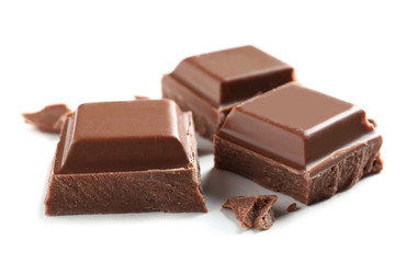 Pieces of tasty milk chocolate on white background