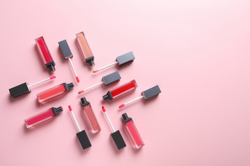 Composition of liquid lipsticks on color background, flat lay. Space for text
