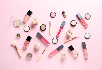 Beautiful composition with lipsticks and flowers on color background, flat lay
