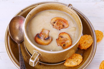 mushroom soup puree with crackers on a wooden table