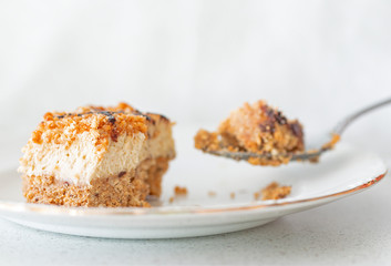 A slice of Amaretti and mascarpone cream pie and a spoon with a bite.