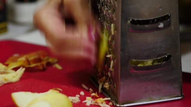 Woman Is Rubbing An Apples On A Vegetable Grater