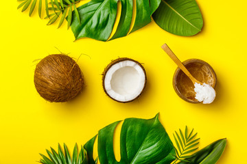 Fototapeta na wymiar Coconut oil, tropical leaves and fresh coconuts
