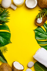 Coconut oil, tropical leaves and fresh coconuts