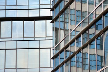 Modern building with reflected sky and cloud in glass window