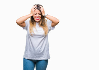 Young beautiful woman casual white t-shirt over isolated background suffering from headache desperate and stressed because pain and migraine. Hands on head.