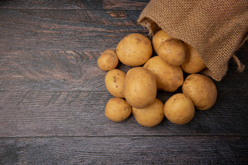 Hessian sack filled with organic potatoes, taken with copy space