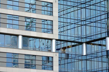 Modern building with reflected sky and cloud in glass window