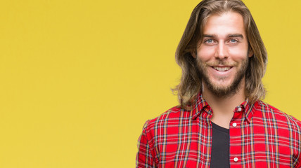 Young handsome man with long hair over isolated background with a happy and cool smile on face. Lucky person.