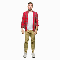 Fototapeta premium Handsome man wearing casual shirt making fish face with lips, crazy and comical gesture. Funny expression.