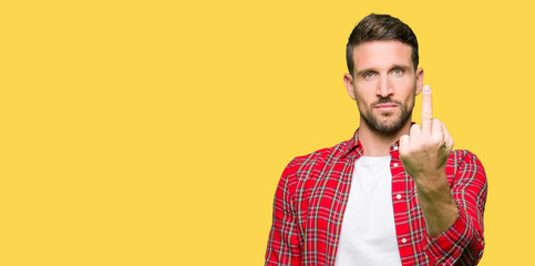 Handsome man wearing casual shirt Showing middle finger, impolite and rude fuck off expression