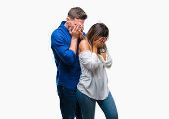 Young couple in love over isolated background with sad expression covering face with hands while crying. Depression concept.