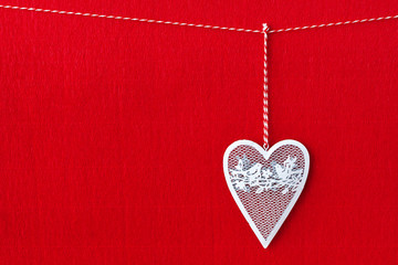 Close up of White heart simbol on red paper background