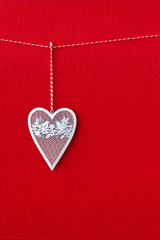 Close up of White heart simbol on red paper background