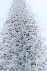 winter snow. path trodden. many footprints. they are dirty.