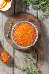 Red caviar in a wooden bowl. Rustic style. Top view