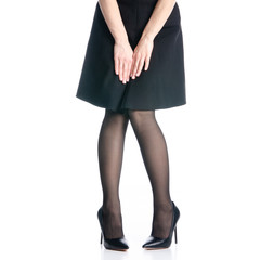 Female legs in black high heels shoes black skirt fashion on white background isolation