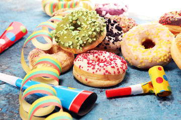 assorted donuts with chocolate frosted, pink glazed and sprinkles donuts