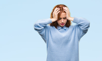 Young beautiful woman over isolated background wearing winter sweater suffering from headache desperate and stressed because pain and migraine. Hands on head.