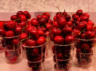 Red sweet cherry in plastic glasses