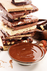 Chocolate bars on table with chocolate tower.