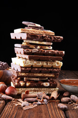 Chocolate bars on table with chocolate tower.