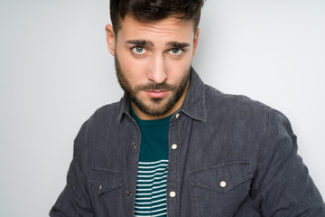 Obraz premium Young handsome man possing and modeling over grey isolated background